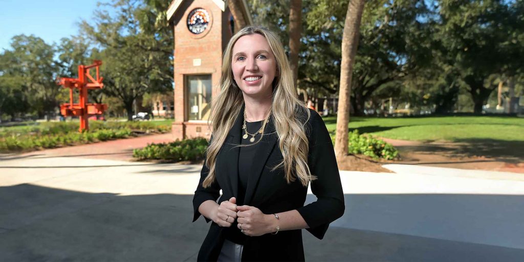 Dr. Andrea Goncher Sevilla smiling outdoors on campus.