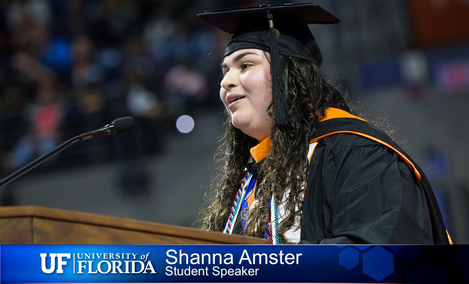 Shanna Amster at podium during graduation.
