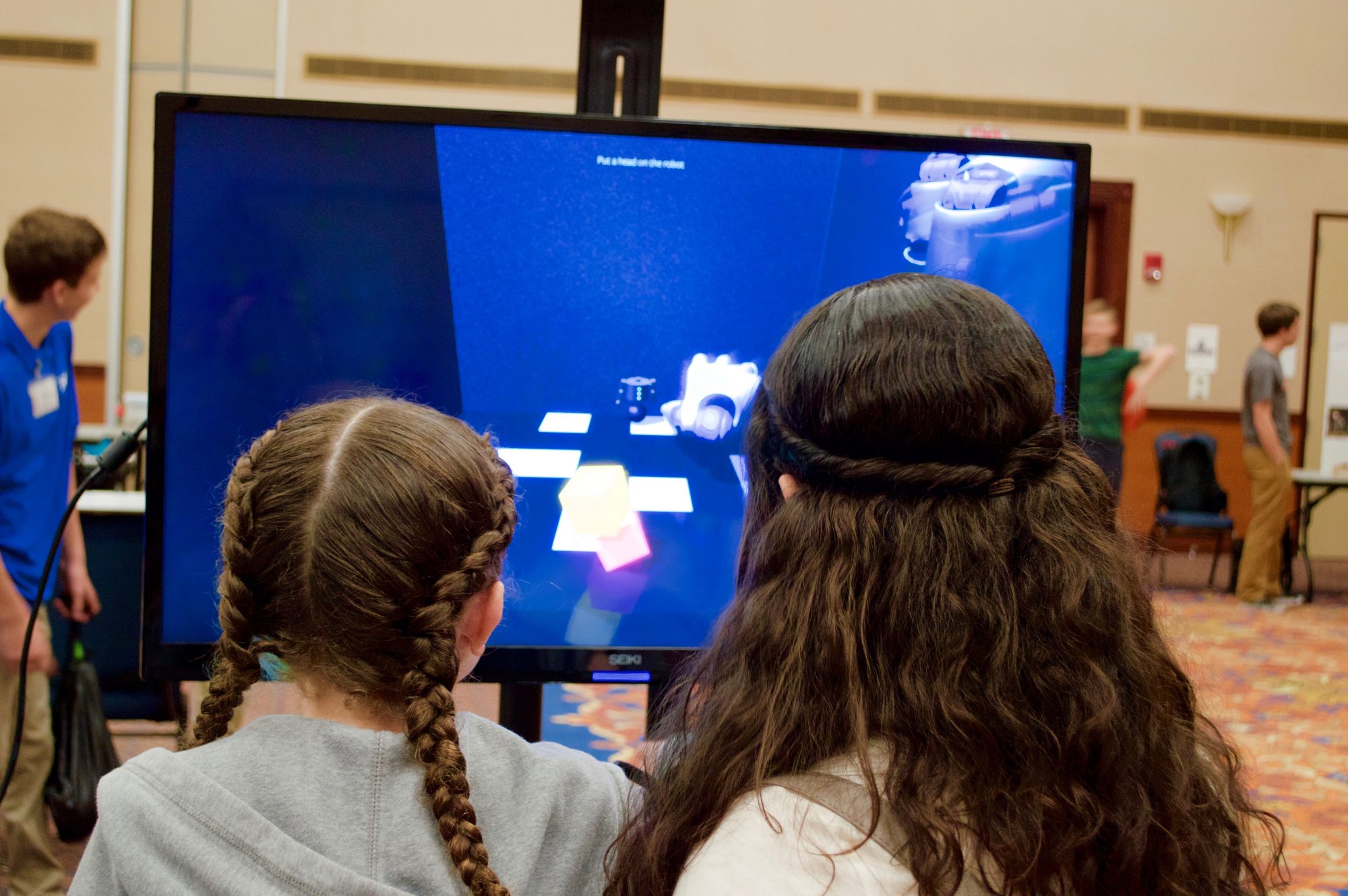 Elementary school-aged students looking at UF technology