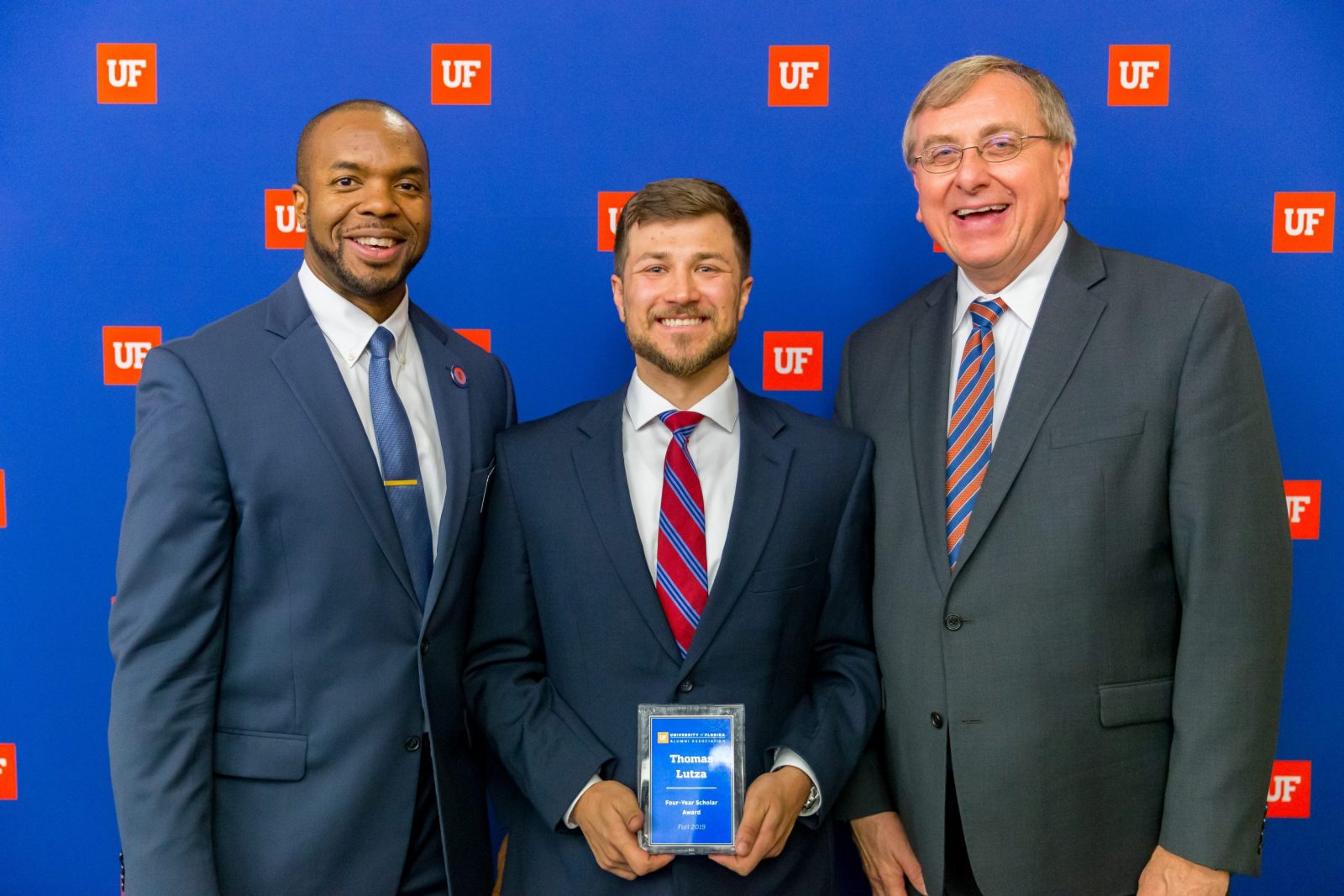 Curtis Taylor, Ph.D and President Fuchs with Thomas Lutza holding award