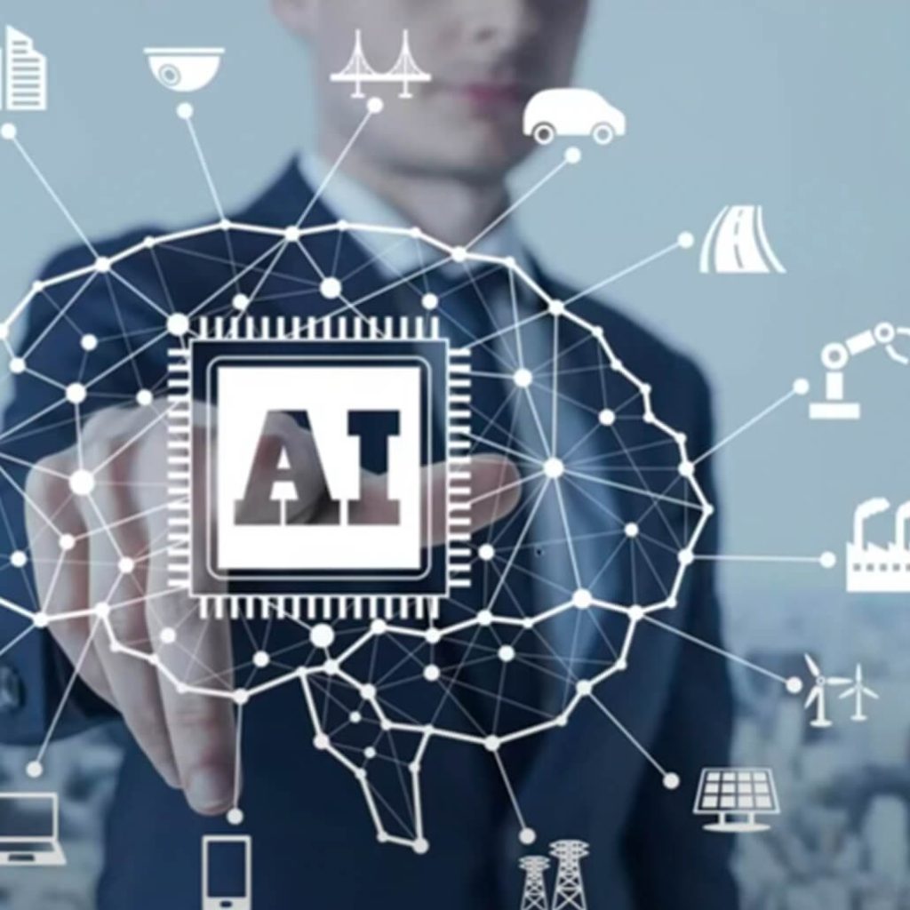 A person in a suite pointing to a superimposed graphic of a human brain and the term "AI"