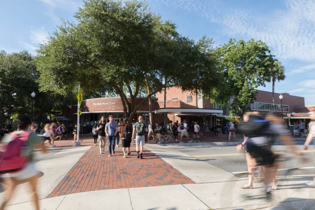 Pedestrians on UF's campus near the Hub