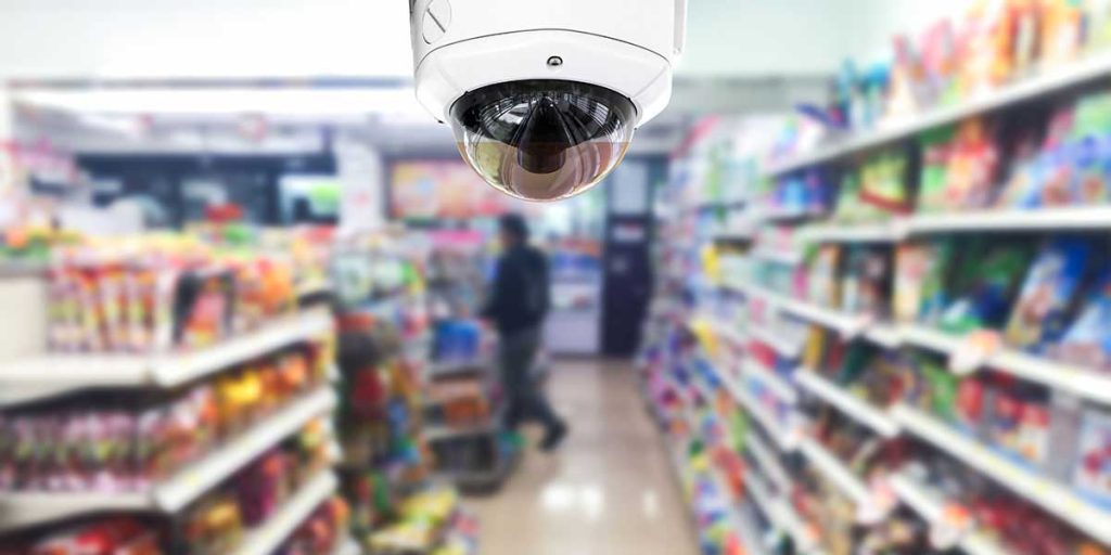 A security camera records footage of a retail store aisle.