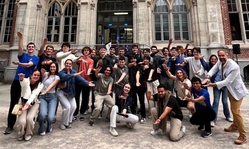 UF in Lille students do the Gator Chomp during International Night, which celebrates different cultures represented at the summer school at the Université Catholique de Lille (pictured in back).
