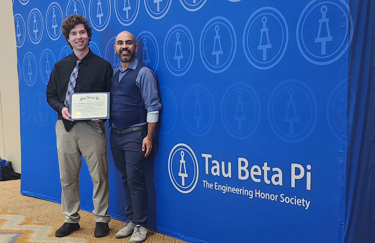 Joseph Hill, left, president of the Tau Beta Pi Florida Alpha chapter, poses with the chapter’s award with Josuan Hilerio Sanchez, Tau Beta Pi director for district 5. Photo submitted by Tau Beta Pi