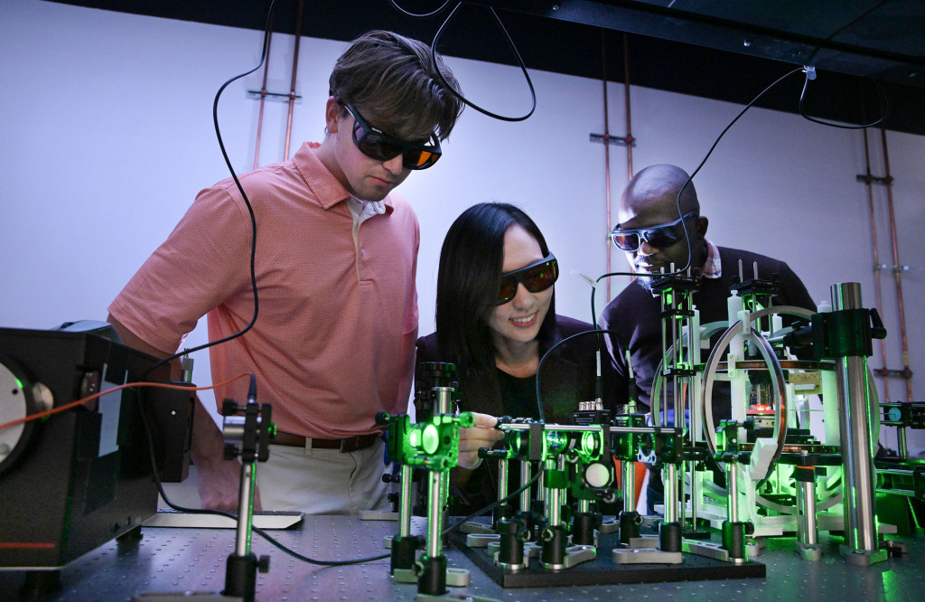Professor Laura Kim, center, is shown in her lab with Ph.D. student Dillon Vann, left, and postdoc Christian Nweze, Ph.D.