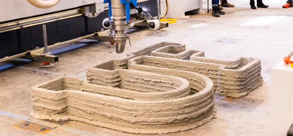 A 3D printer printing the UF monogram.