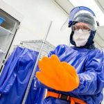 Dr. Brent Gila dons his PPE to work in the NRF cleanroom.