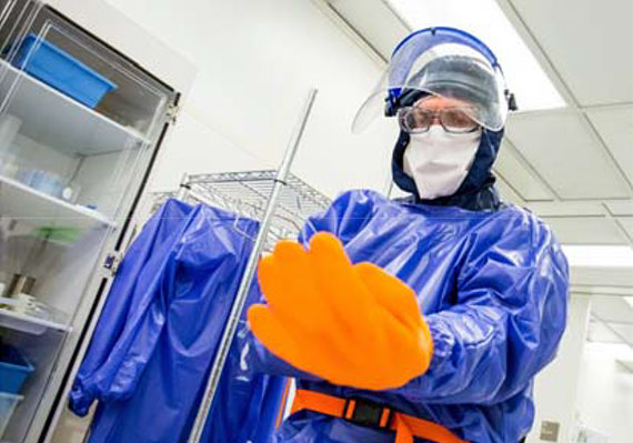 Dr. Brent Gila dons his PPE to work in the NRF cleanroom.