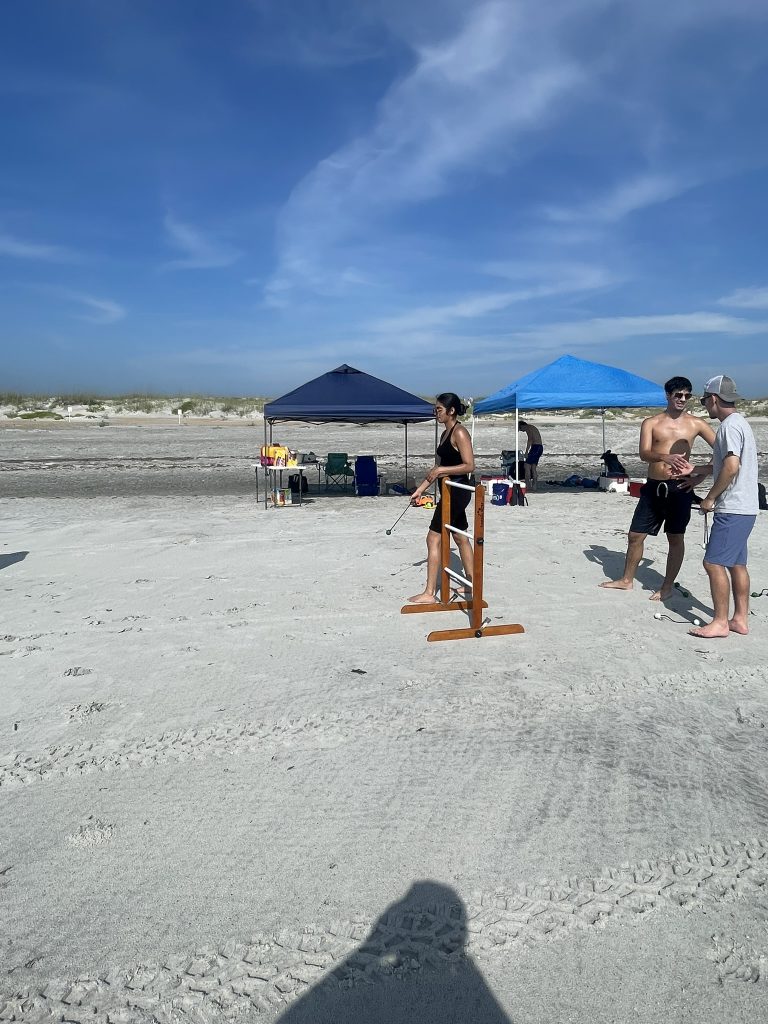 A student taking their turn and tossing during ladder golf. 