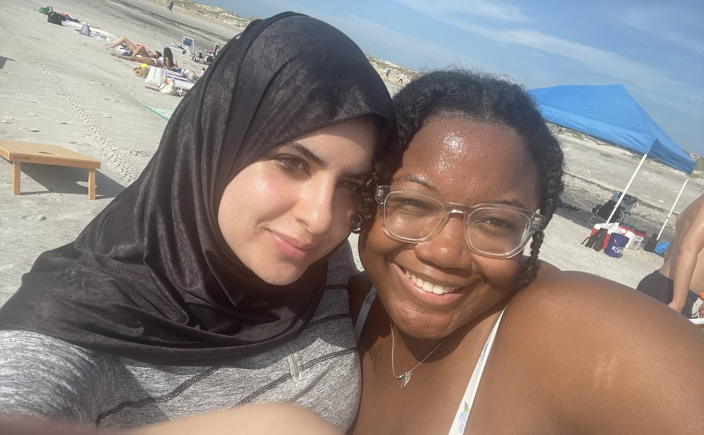 A student and staff member taking a selfie together. 