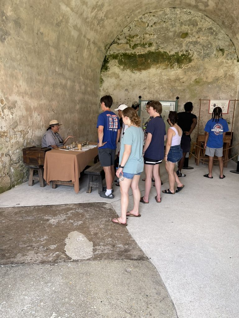 Students speaking with a park ranger about artifacts. 