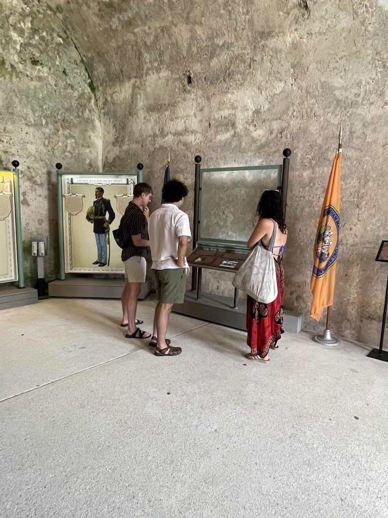 Students observing flag and reading informational signs. 