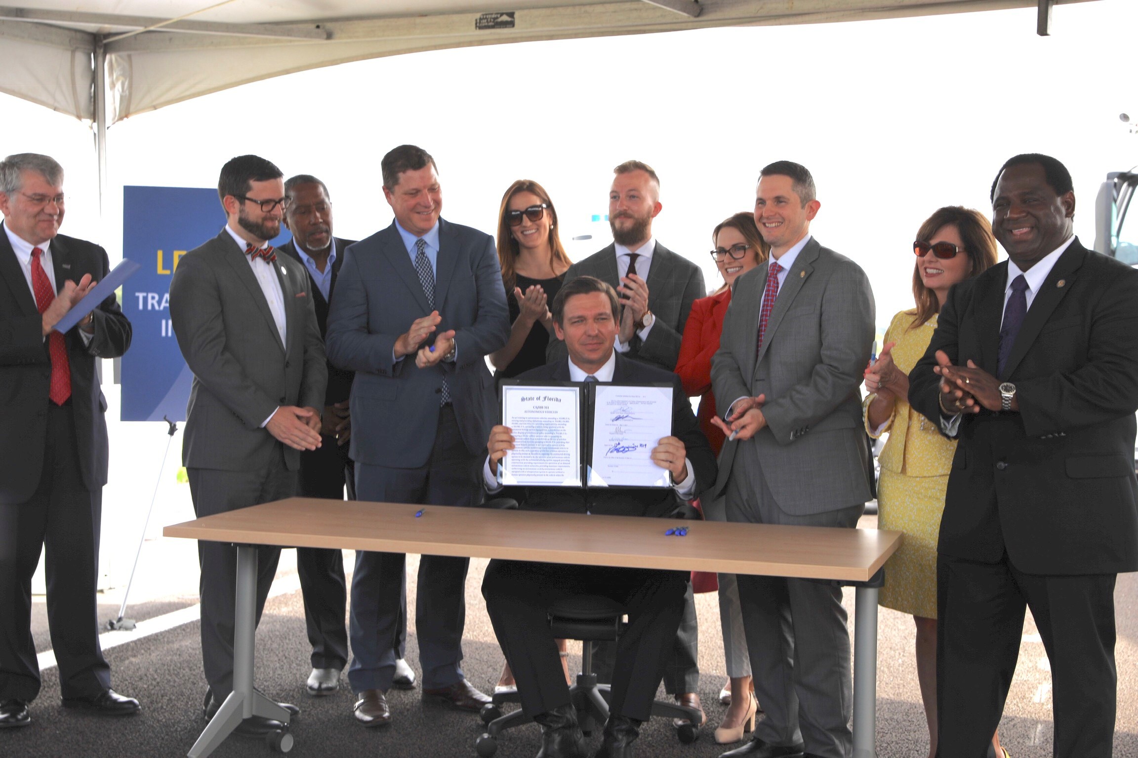 Governor Ron DeSantis holds up the signed House Bill 311. Photo Credit: Governor’s Press Office